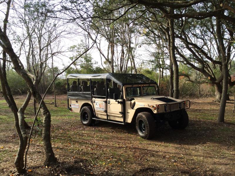 a truck parked on the side of a dirt field