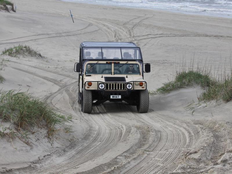 a bus driving down a dirt road